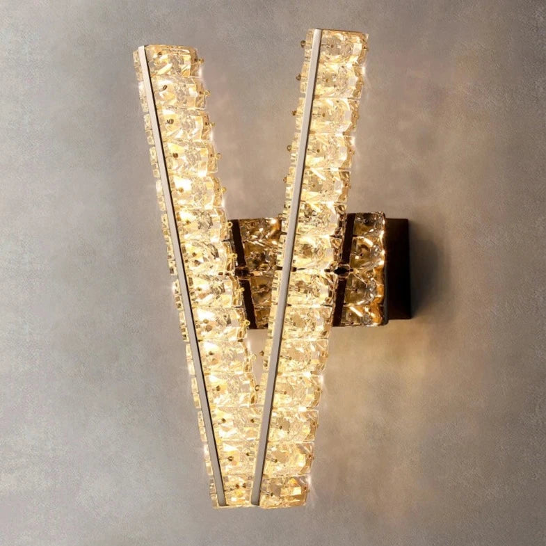 Signature V diamond cut crystal wall sconce installed in refined interior creating dramatic architectural accent
