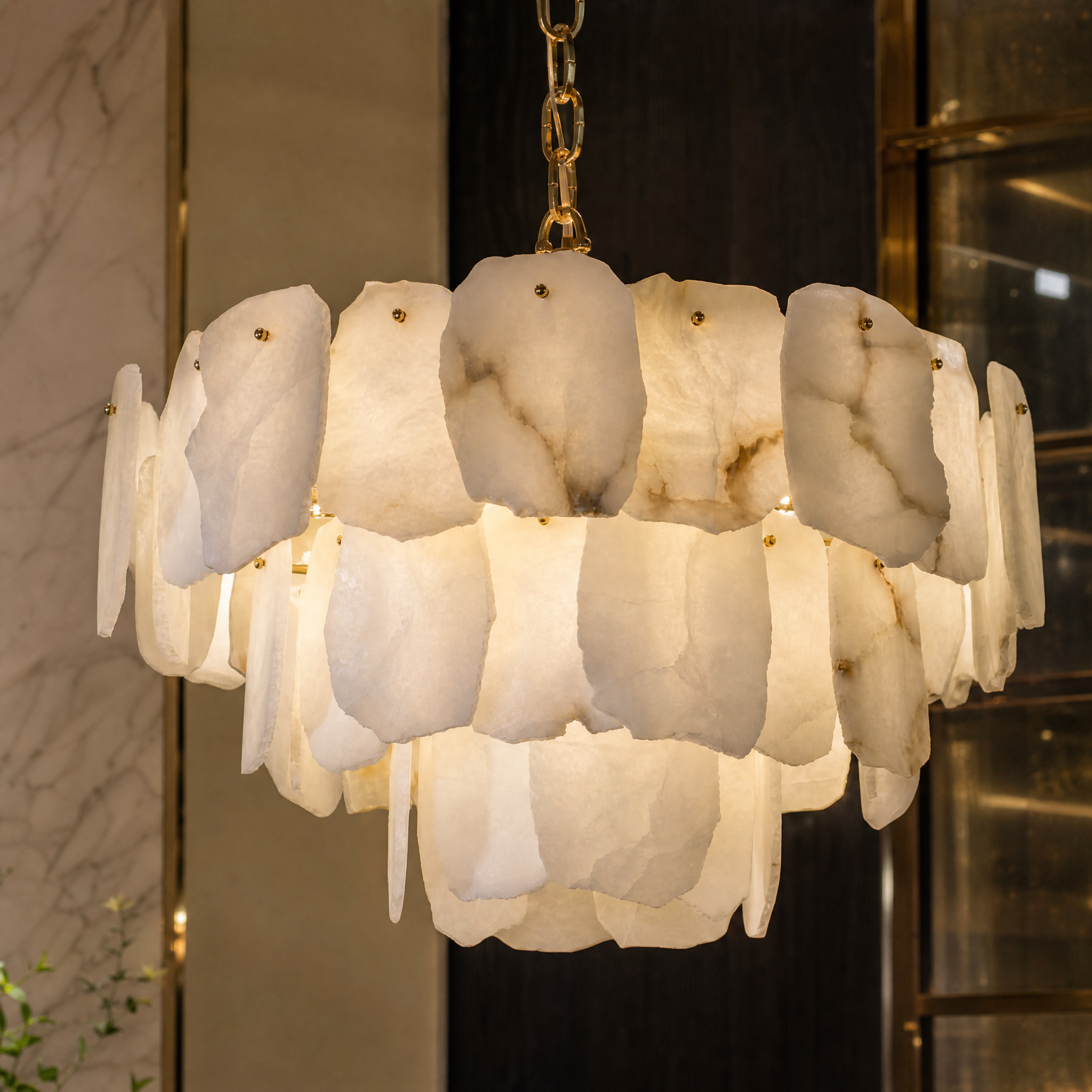 A detailed close-up of the handcrafted natural marble panels on the VORELLI Silvio Circular Chandelier, showcasing the gentle translucence of the stone.