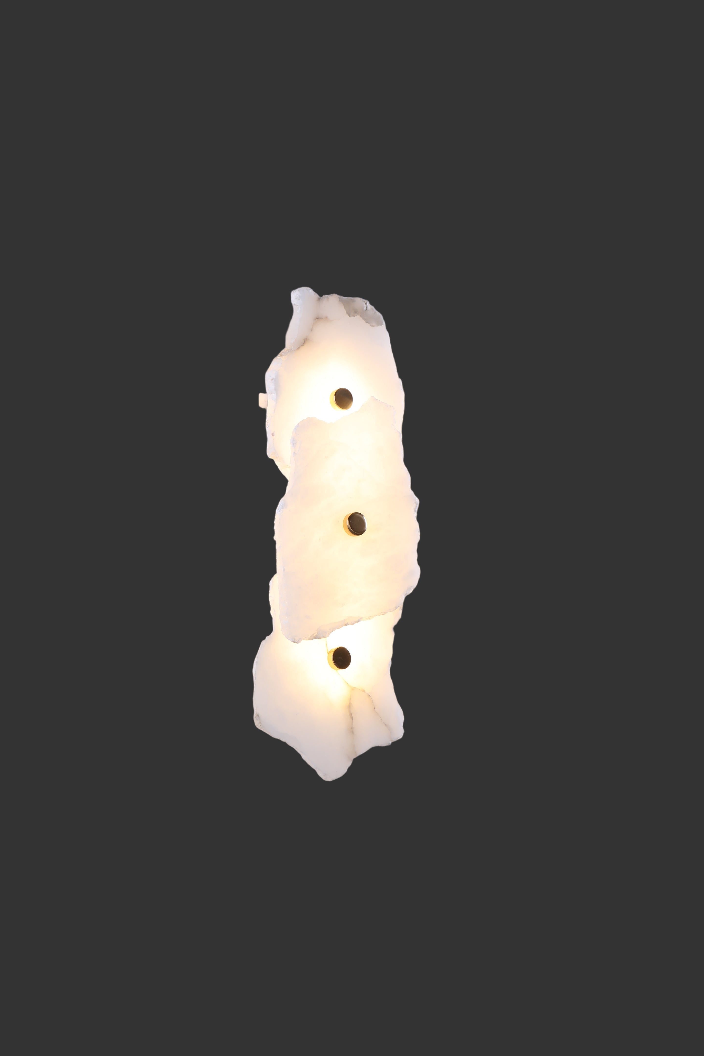 Profile view of sculptural layered marble form on Silvio wall sconce