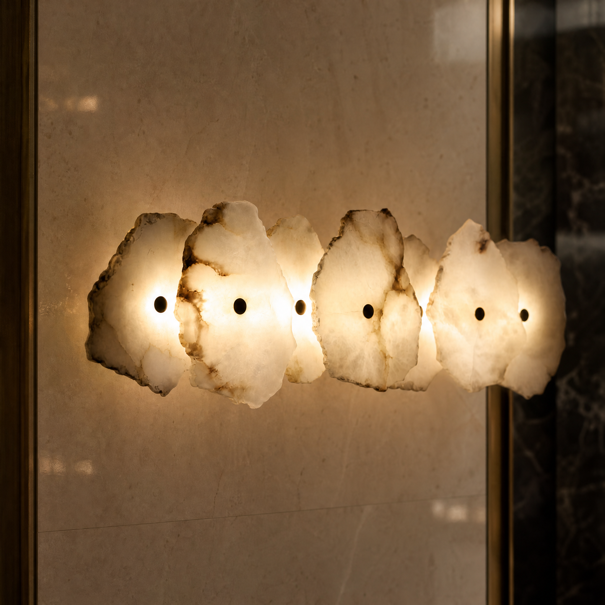 Closeup detail of the natural marble veining and sculptural form of the VORELLI Silvio wall light