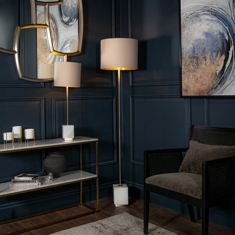 Sintra floor lamp featuring solid block base and slender brass stem with fabric shade styled in modern living interior