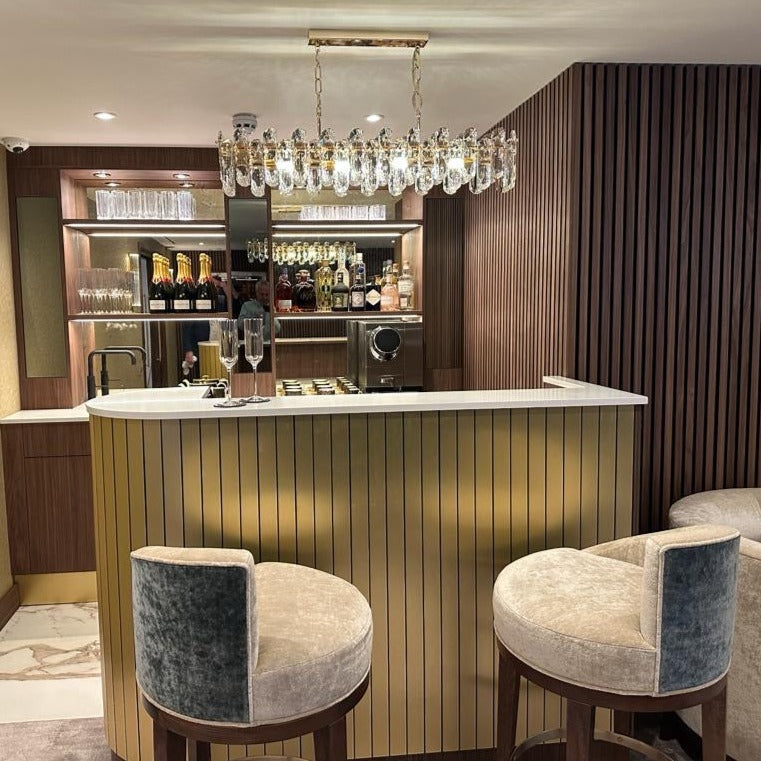Stellina modern oblong crystal rectangular chandelier installed above dining or bar area