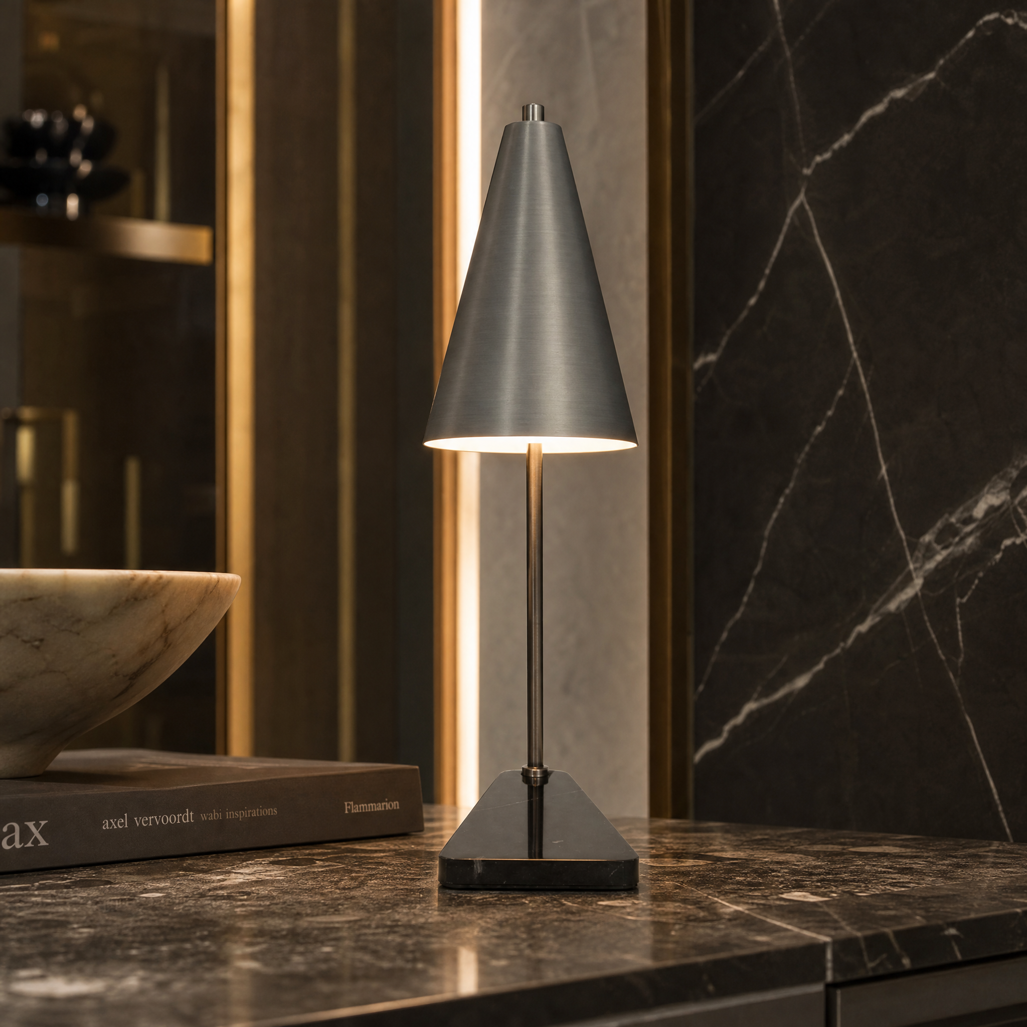 A detailed closeup shot of the Strava table lamp highlighting its refined gunmetal tapered silhouette and premium solid marble base.