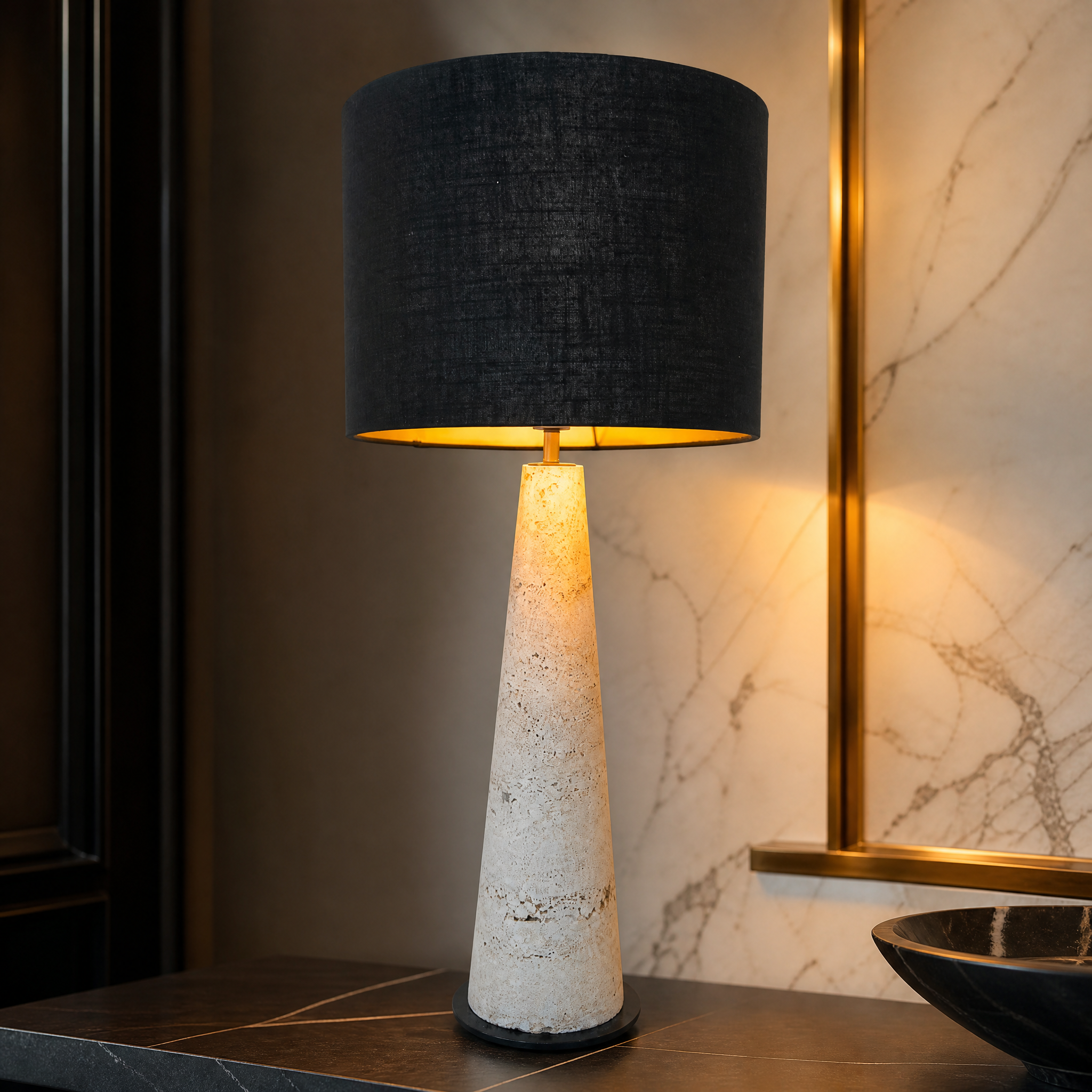 Macro closeup of the VORELLI Tavira lamp, showcasing the rich texture of the sculpted natural travertine stone base contrasted with the dark textile shade.