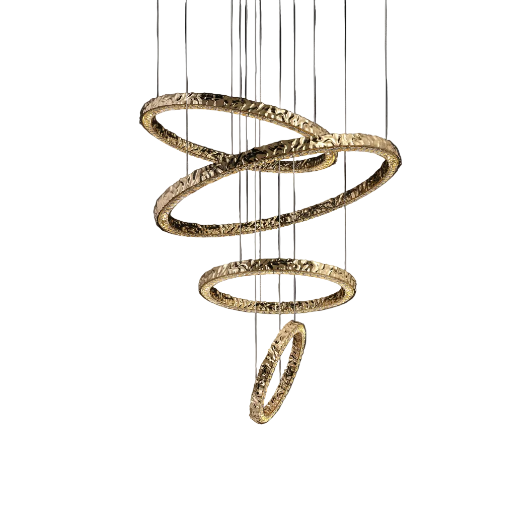 The Ecliptica Ring Staircase Chandelier by VORELLI casting a warm, elegant glow through layered, intersecting gold bands in an expansive open-layout interior.