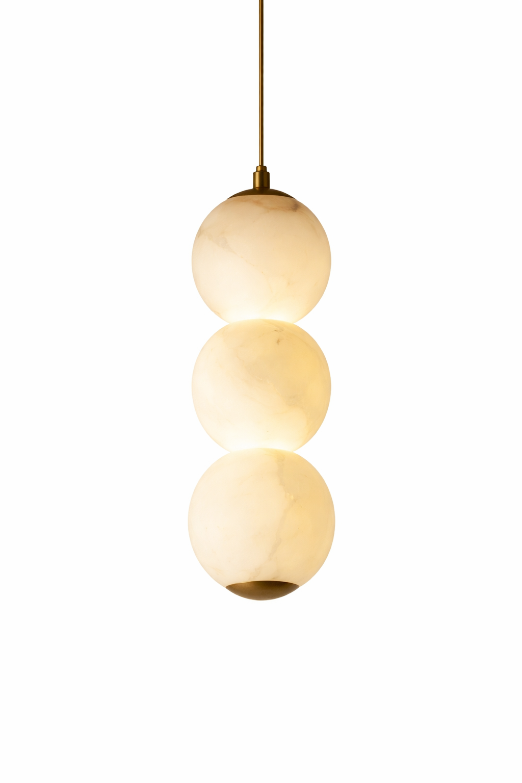 The quiet sophistication of the Thea Marble Pendant Light, highlighting the soft veining of the marble spheres radiating a warm, moody ambiance.