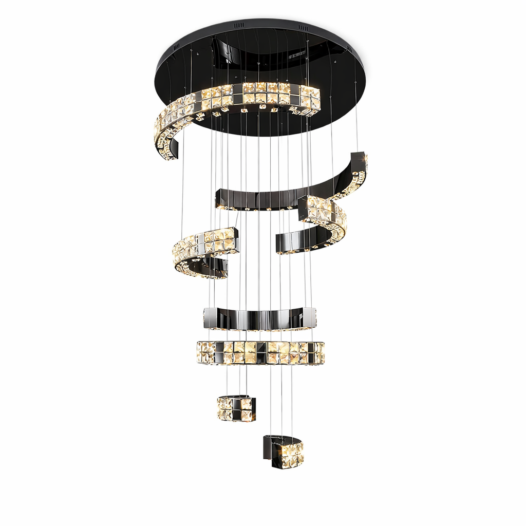 The VORELLI Minato staircase chandelier throwing a brilliant, warm glow across a modern minimalist interior, highlighting its dramatic architectural structure.