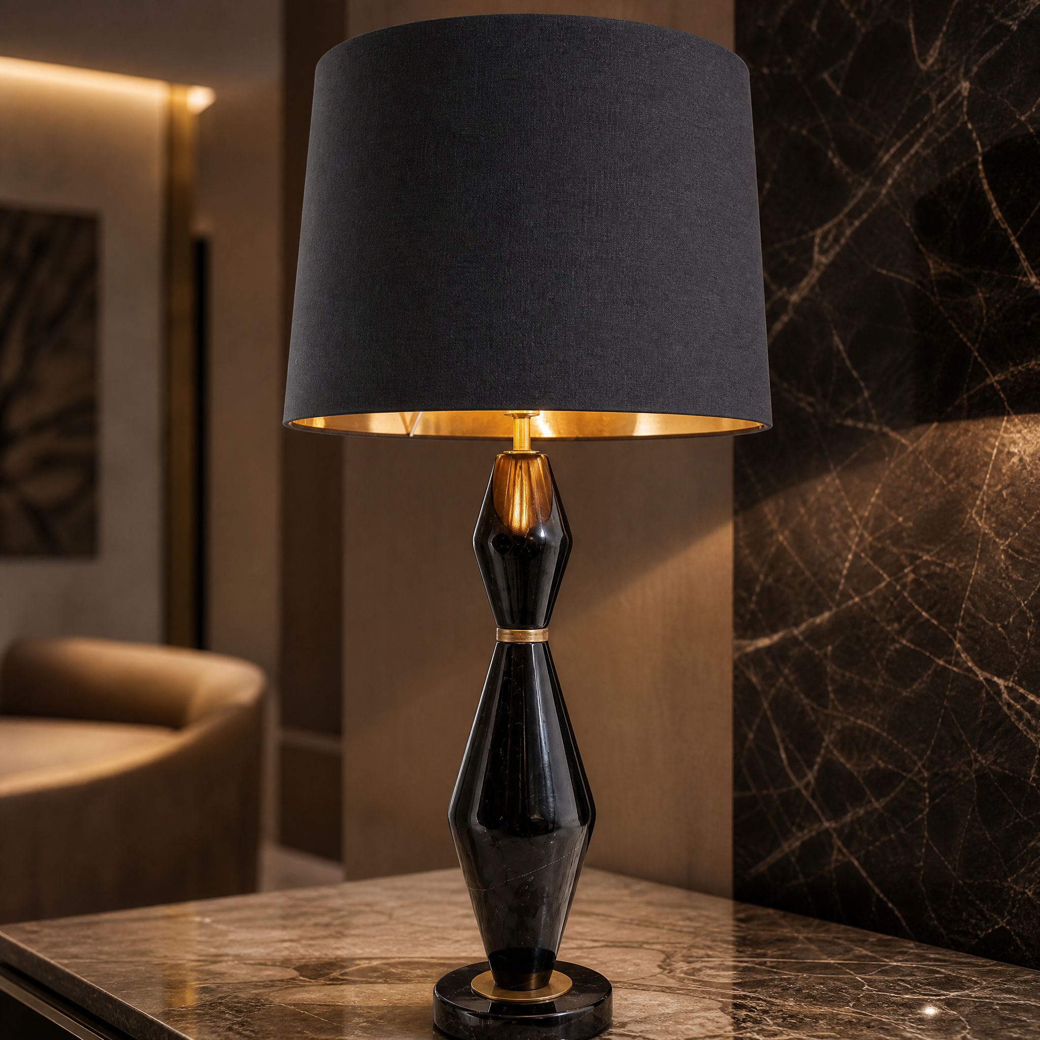 Detailed closeup of the VORELLI Thelora lamp showing the rich textures of the black marble base, refined antique brass details, and black fabric shade.