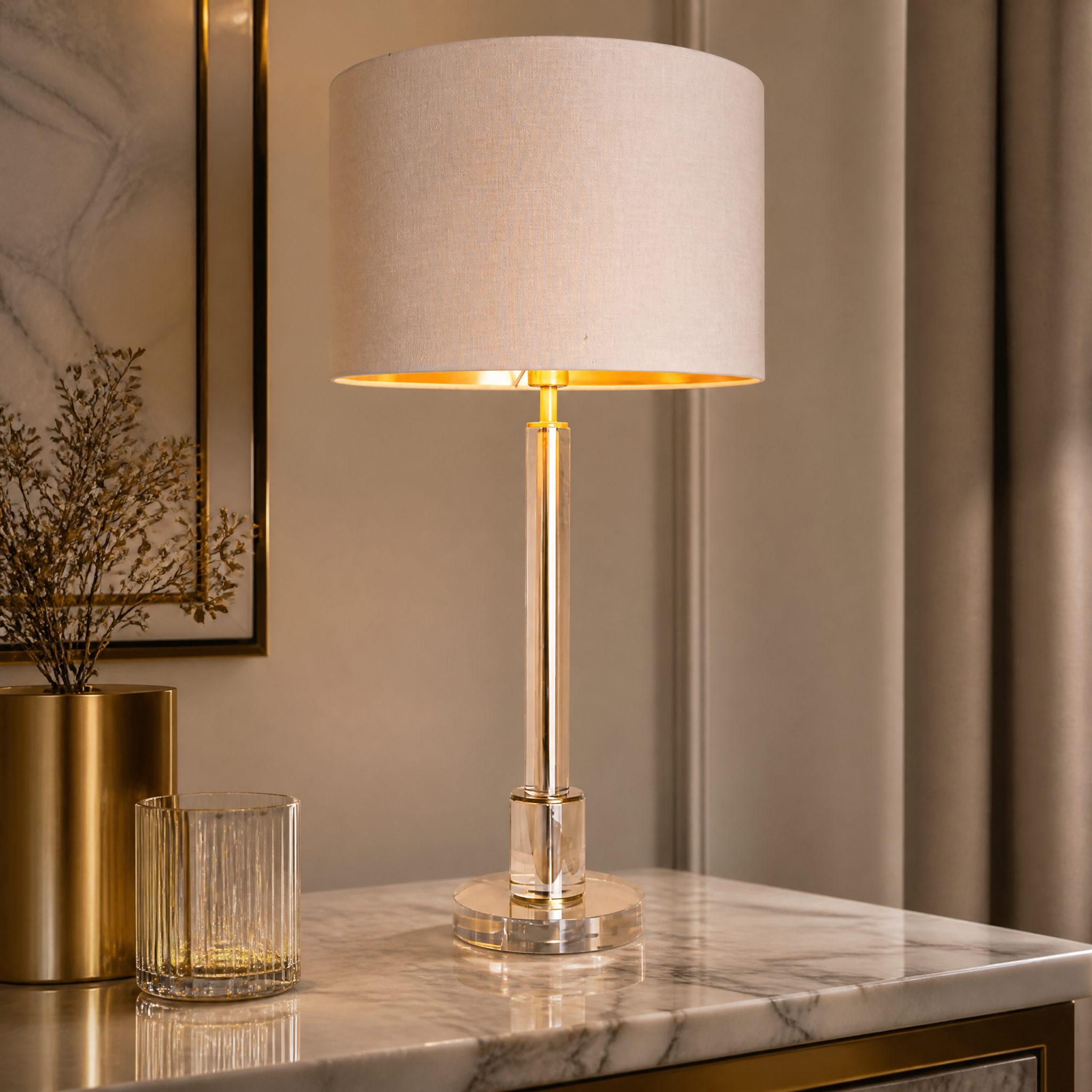 A detailed closeup of the Torello table lamp showcasing the gently tapered crystal stem, warm antique brass base, and refined fabric shade texture.