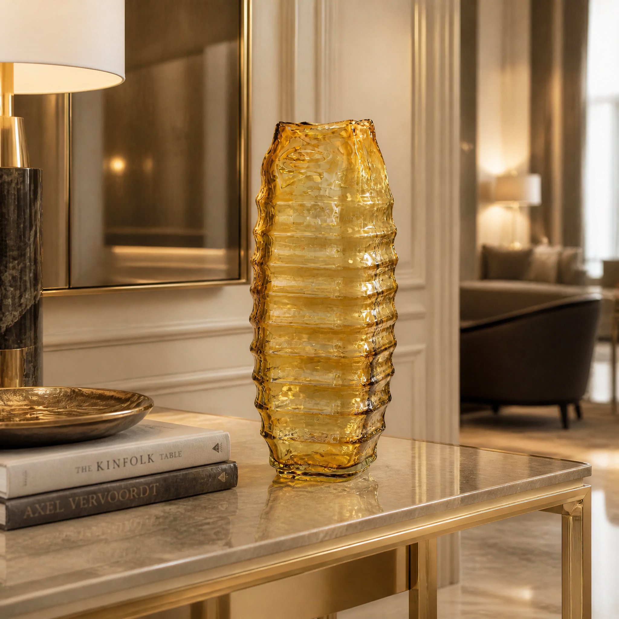 Large yellow glass Valdese vase with a square base displayed as a sophisticated sculptural accent in a high-end hotel lobby.