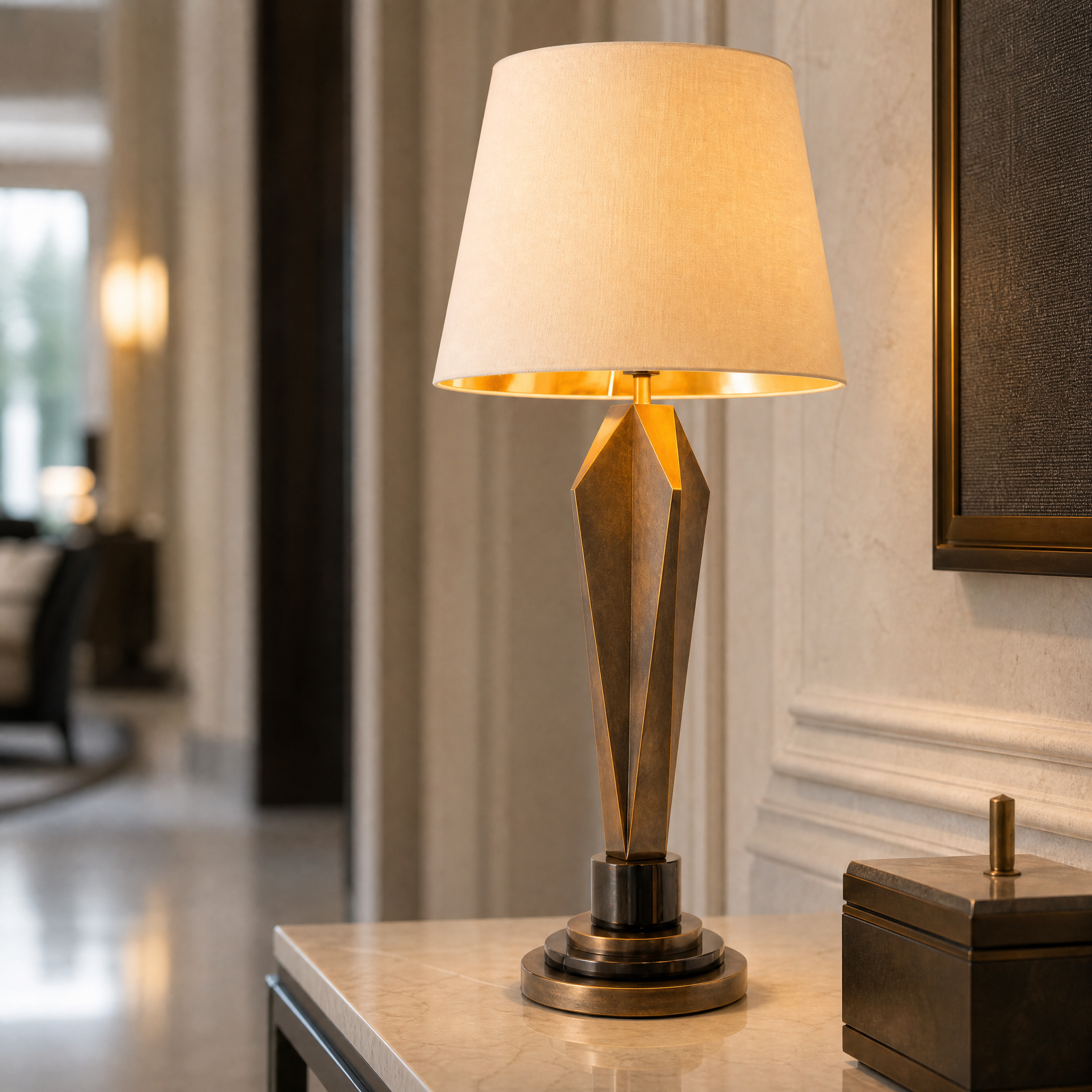 Close-up of the Valdorin table lamp showing sculptural brass detailing and refined black marble texture.