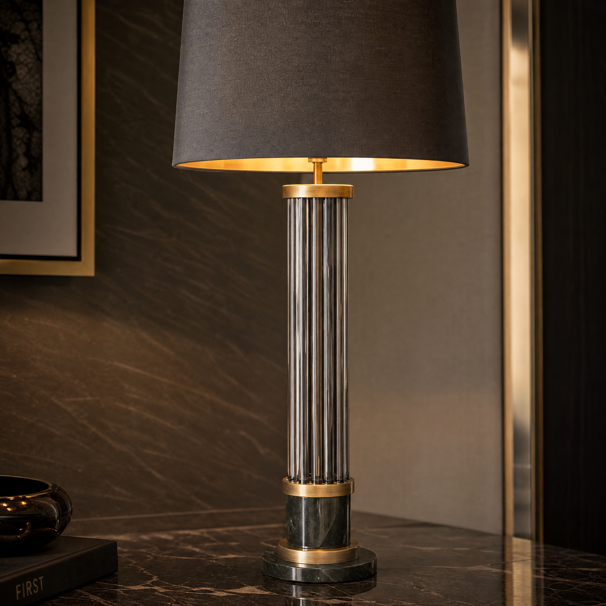 A detailed close-up shot of the Valenro lamp showcasing the layered smoke glass rods, warm brass framing, and the solid black marble base.