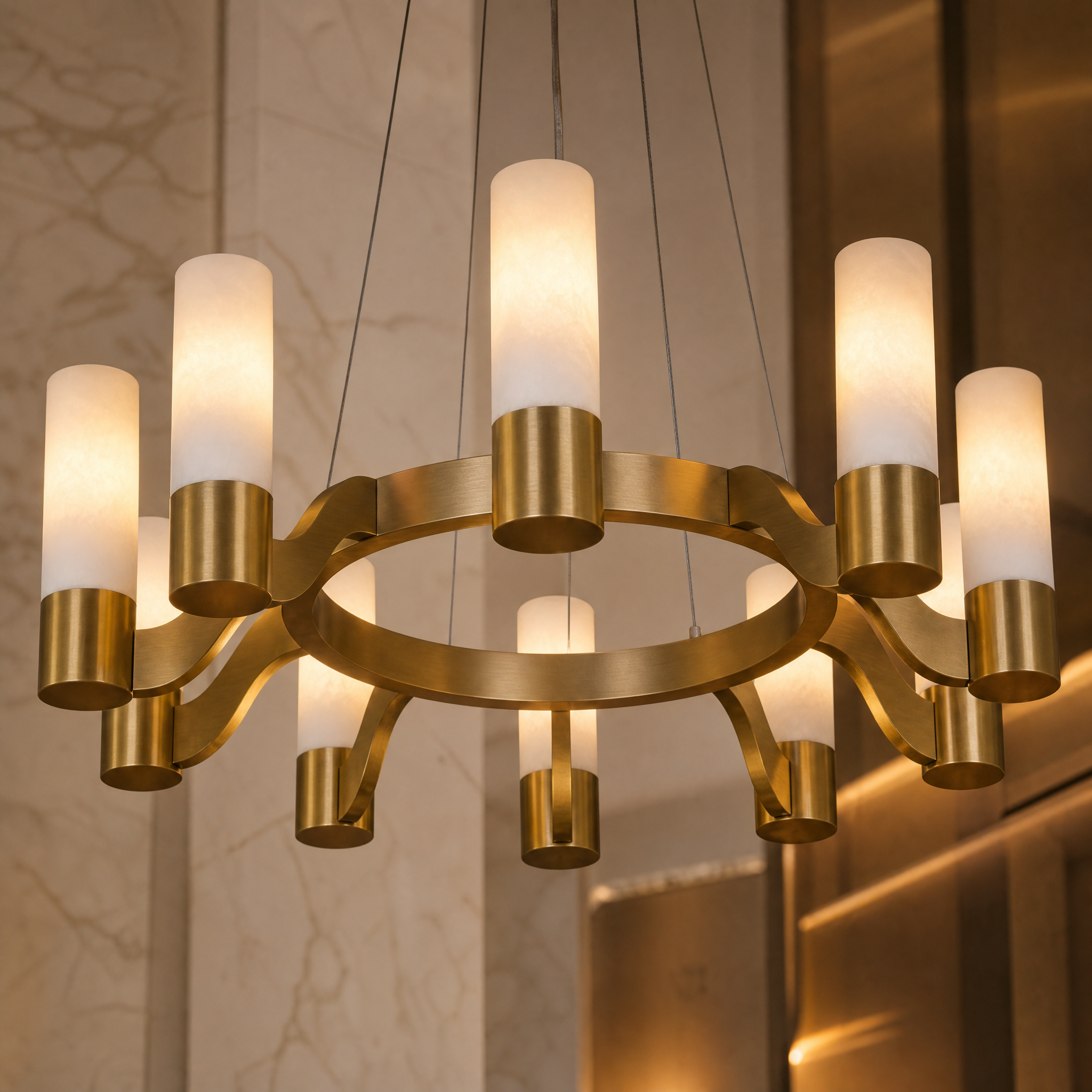 A detailed close-up of the VORELLI Valenza circular chandelier, highlighting the refined ring frame and elegant cylindrical marble shades.