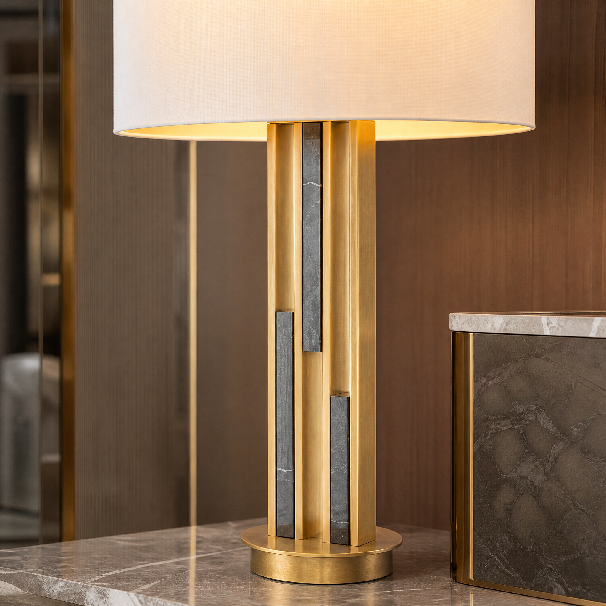 Close up detail of the brushed brass frame and elegant black marble inlay on the Valenzo table lamp