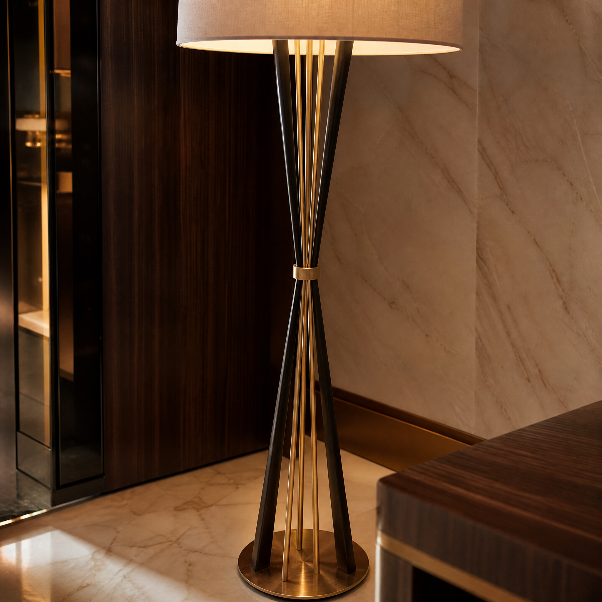 Close-up detail of the VORELLI Valtero floor lamp, showcasing the architectural elegance of the dual-tone antique brass sculpted base and refined tapered silhouette.