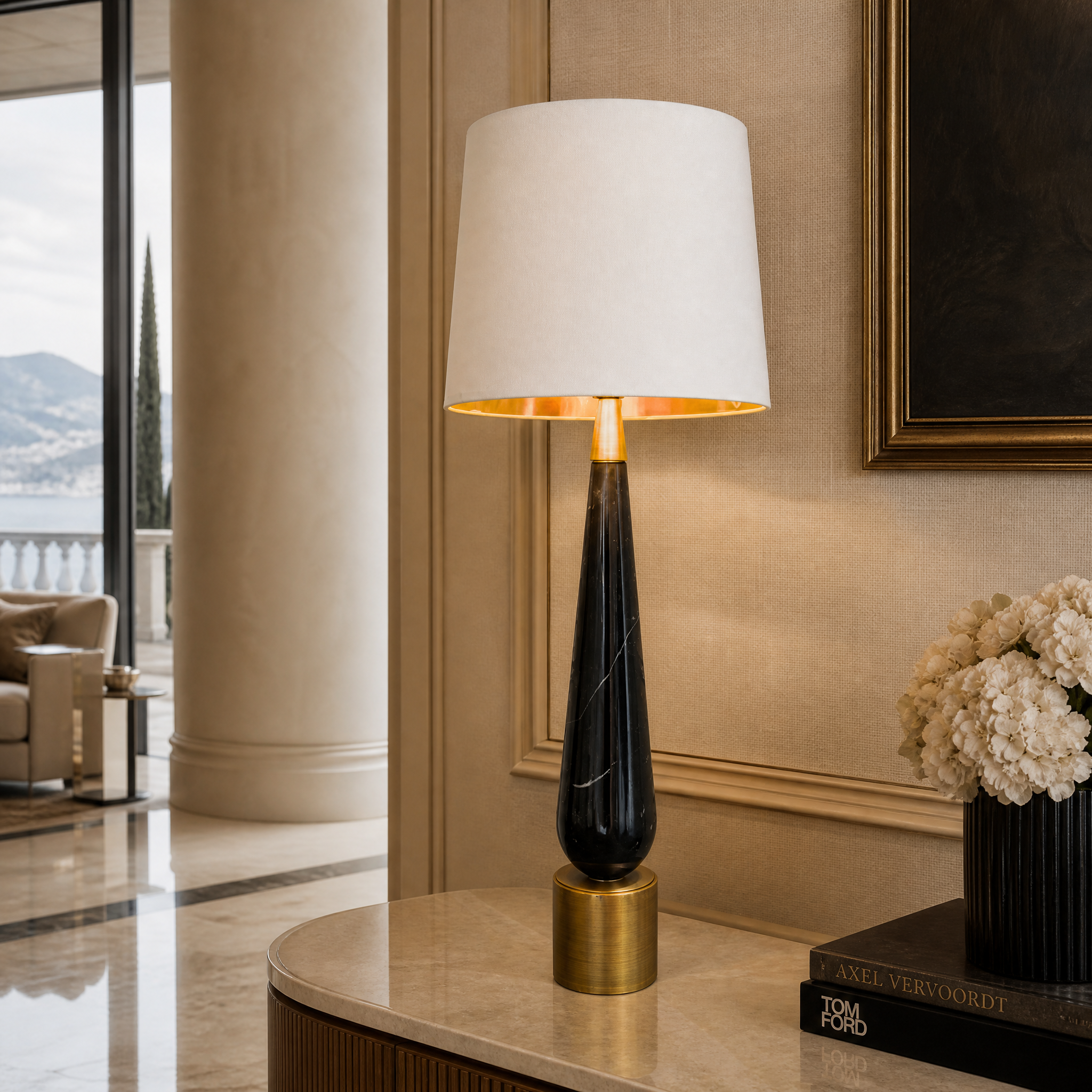 A sleek Velcore brass and marble table lamp placed on a luxury side table in a modern living room setting.
