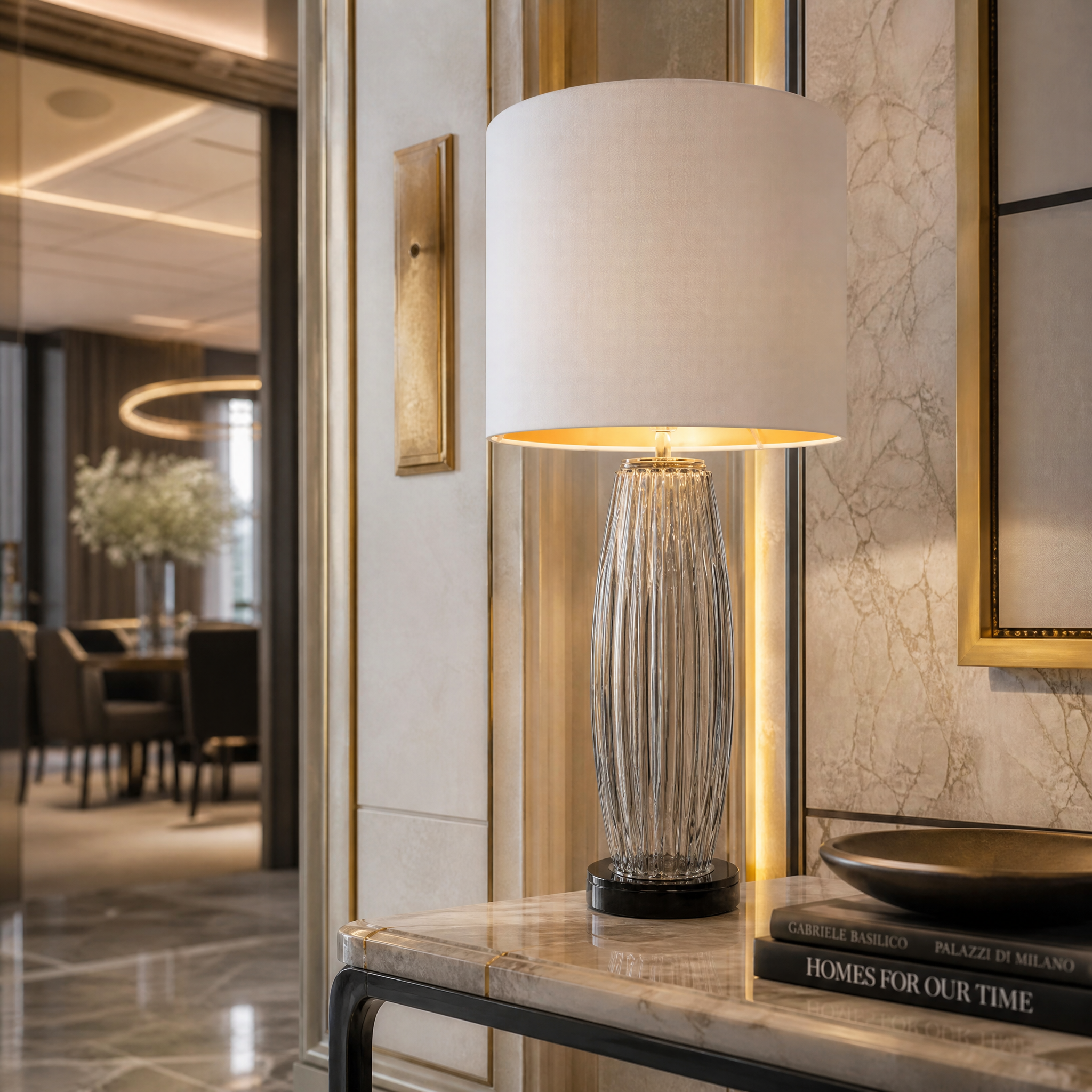 Velora table lamp featuring smoked glass and black marble in an upscale hotel bedroom interior.