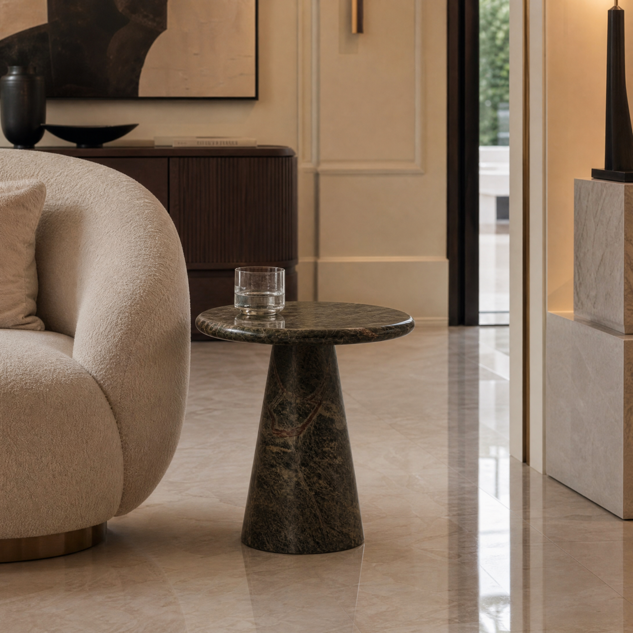 Contemporary VORELLI Veronese solid forest green marble side table styled in a modern residential living room setting next to a luxury sofa.