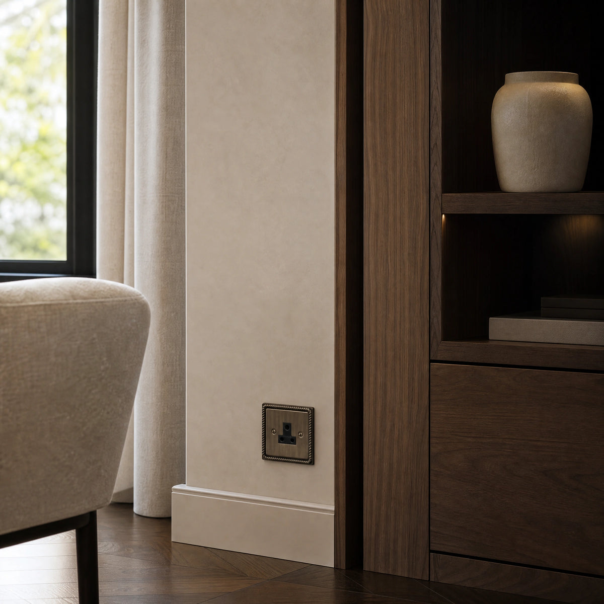Luxury antique brass 5a socket installed within bespoke bedside joinery or low-level wall beside a luxury seating area in a UHNW interior by VORELLI®.