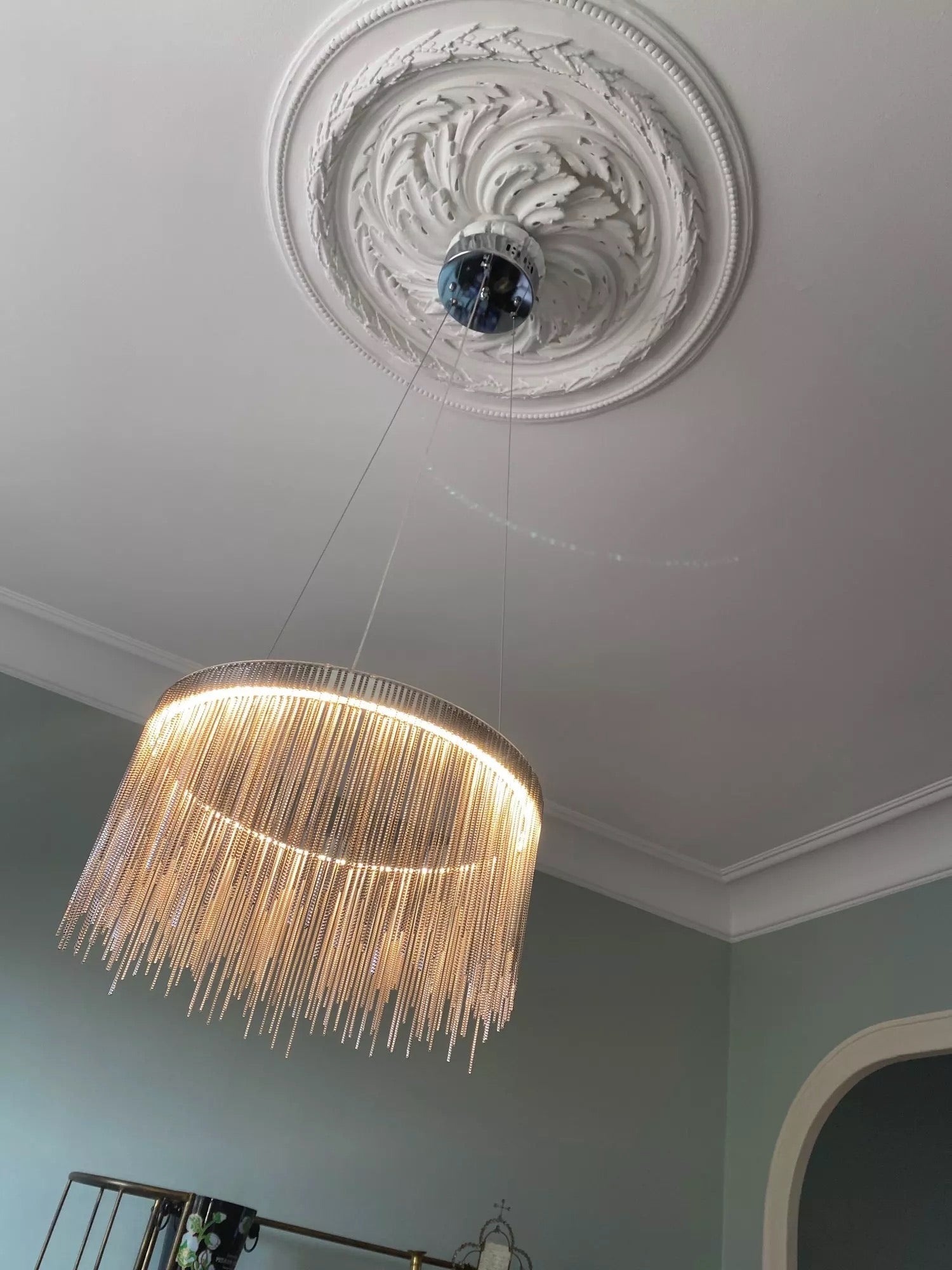 Adlington circular chandelier by VORELLI® with illuminated crystal chains and decorative ceiling rose in a luxury interior setting
