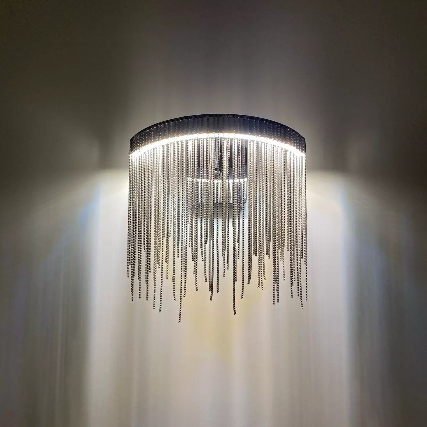 Close-up of VORELLI® Adlington Wall Light illuminating a curved wall with warm light