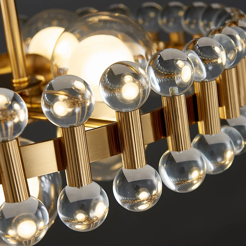 Close-up image of Alytus Rectangular Chandelier II showing transparent crystal cubes and sleek gold structure.
