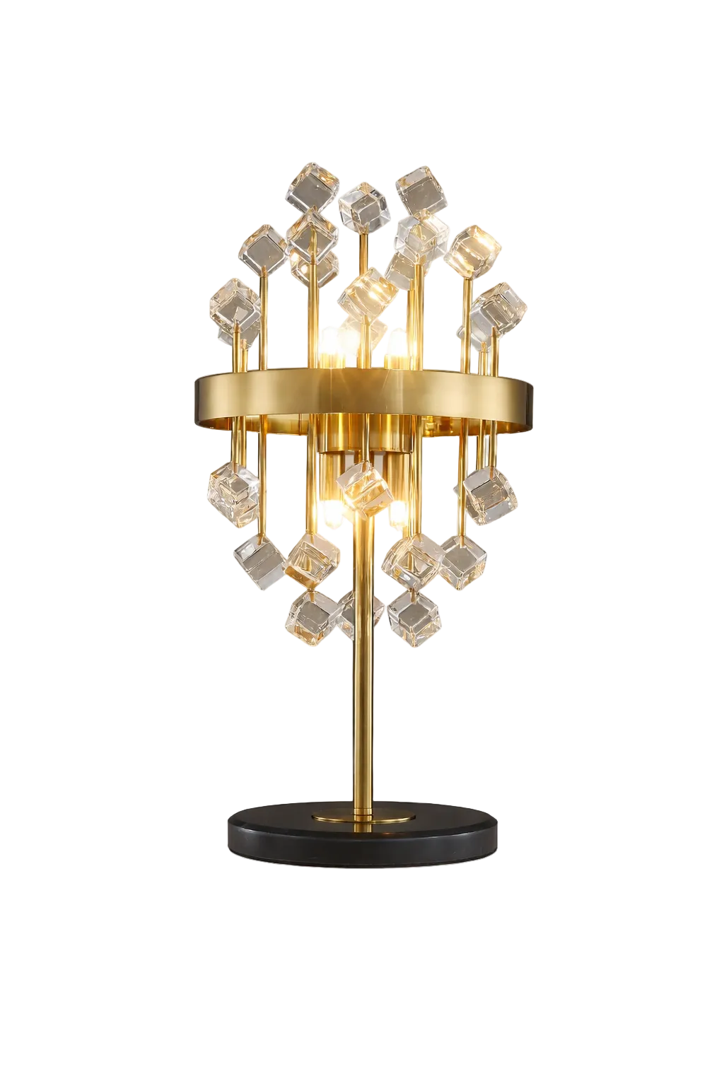 Luxury gold table lamp with clear crystal cube accents and warm glowing bulbs, placed on a bedside table in a modern bedroom interior with neutral tones and decorative vase.