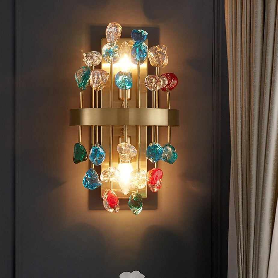 Alytus Wall Light featuring a gold sculptural frame with playful multicoloured glass spheres, styled against a curtain backdrop.