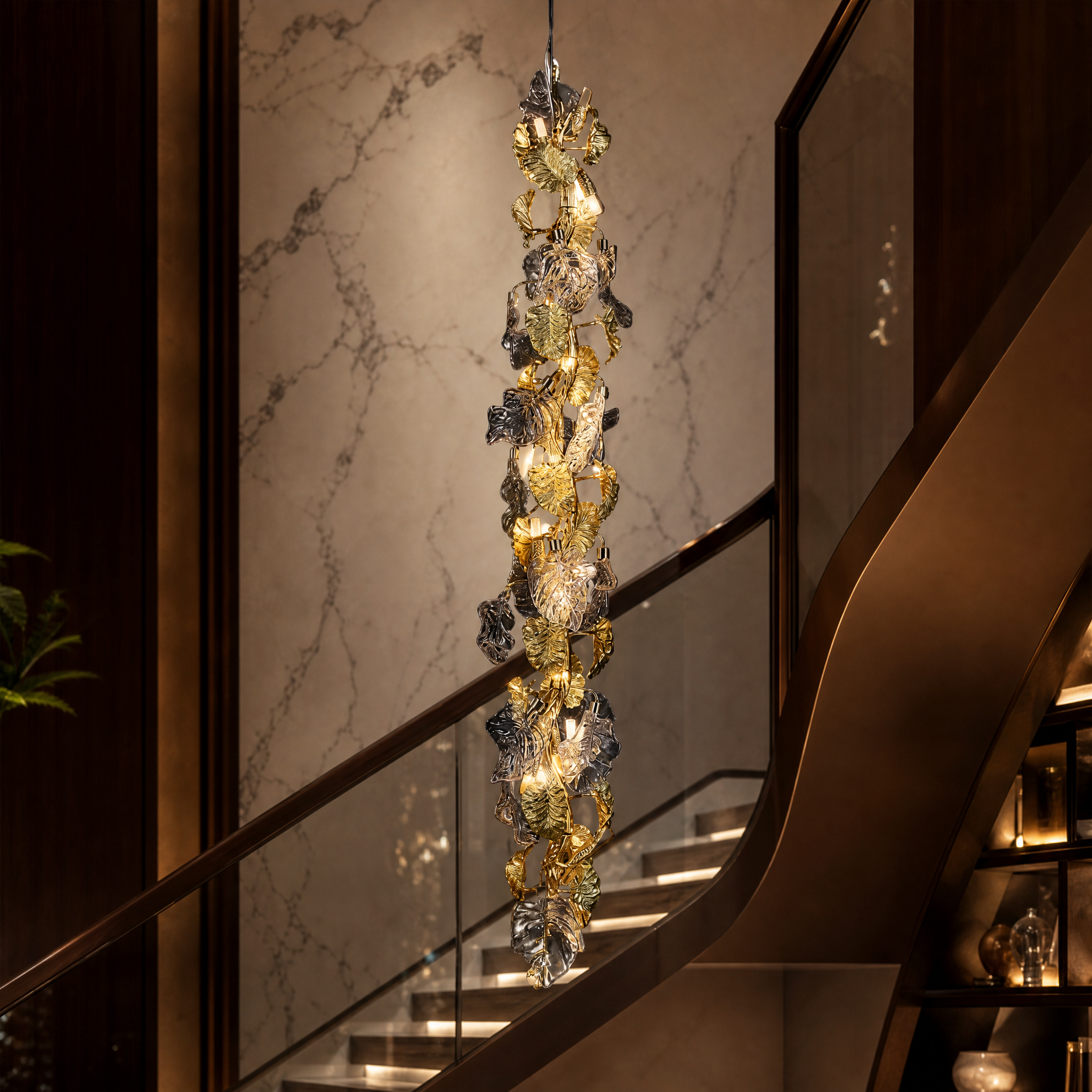 Detailed closeup of the VORELLI Aura Leaf Linear Staircase Chandelier II showing the exquisite craftsmanship of the sculptural glass leaves.