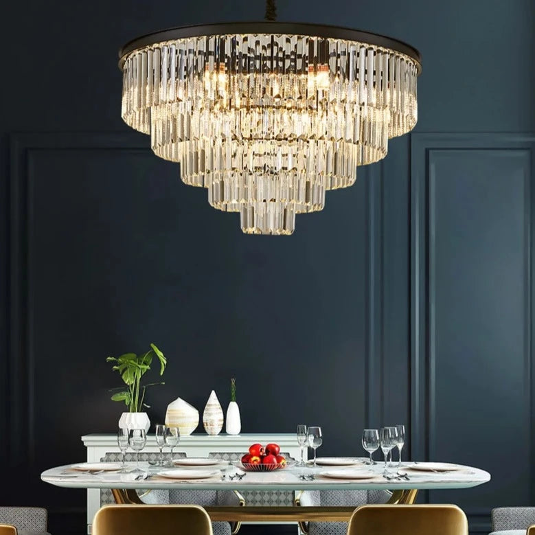 Tiered circular chandelier illuminating a contemporary dining space.
