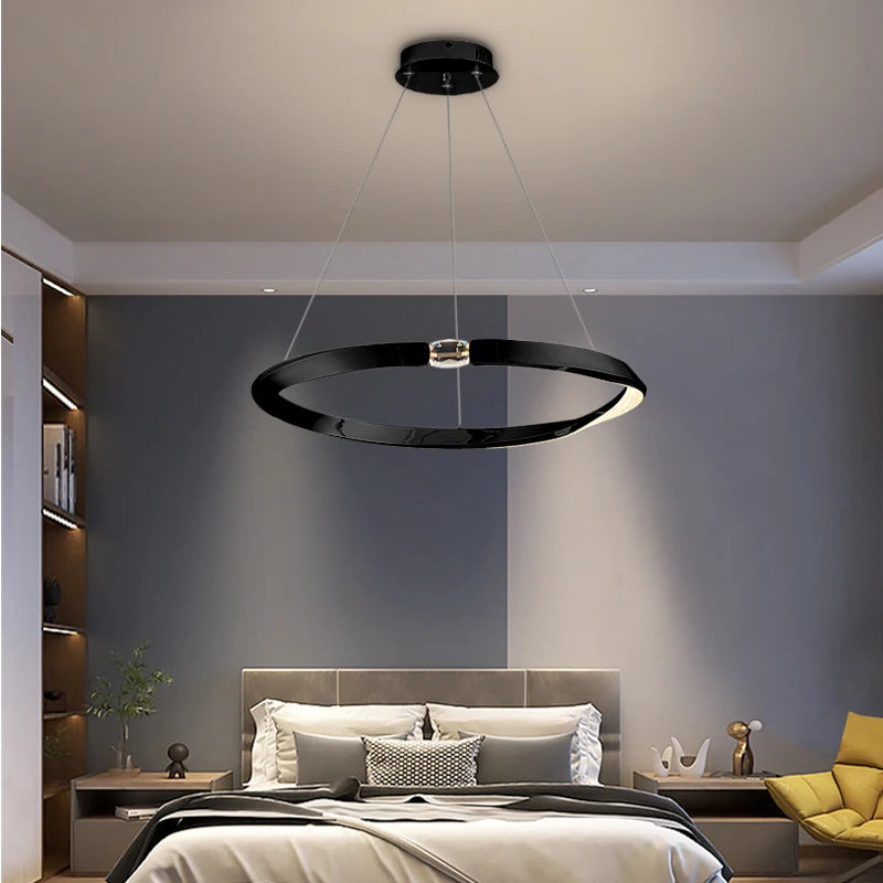 Circular crystal chandelier adding a refined ambiance to a contemporary bedroom.