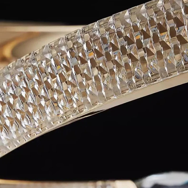 Detailed close-up of diamond cut crystal and sleek circular frame on the Belgravia chandelier.