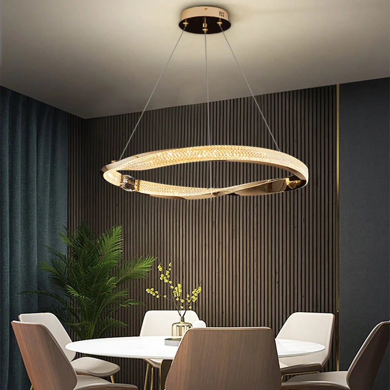 Luxury circular chandelier with diamond cut crystal illuminating a modern dining room.