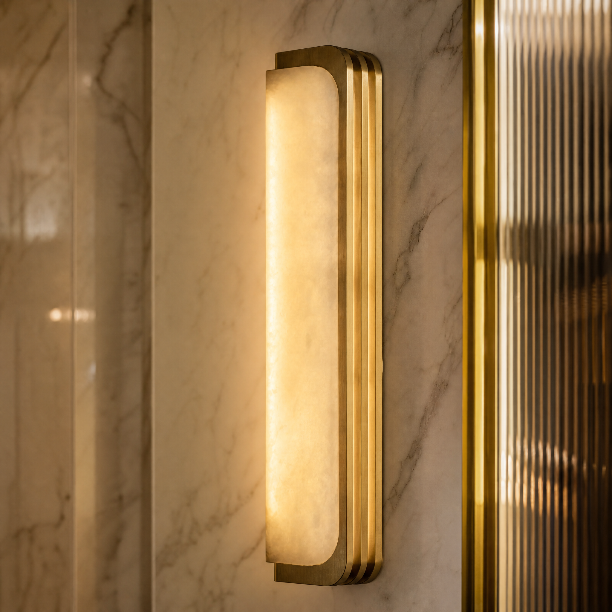 Macro shot of the VORELLI Bellagio wall light showing the intricate veins of the natural marble diffuser and its finely sculpted linear frame.