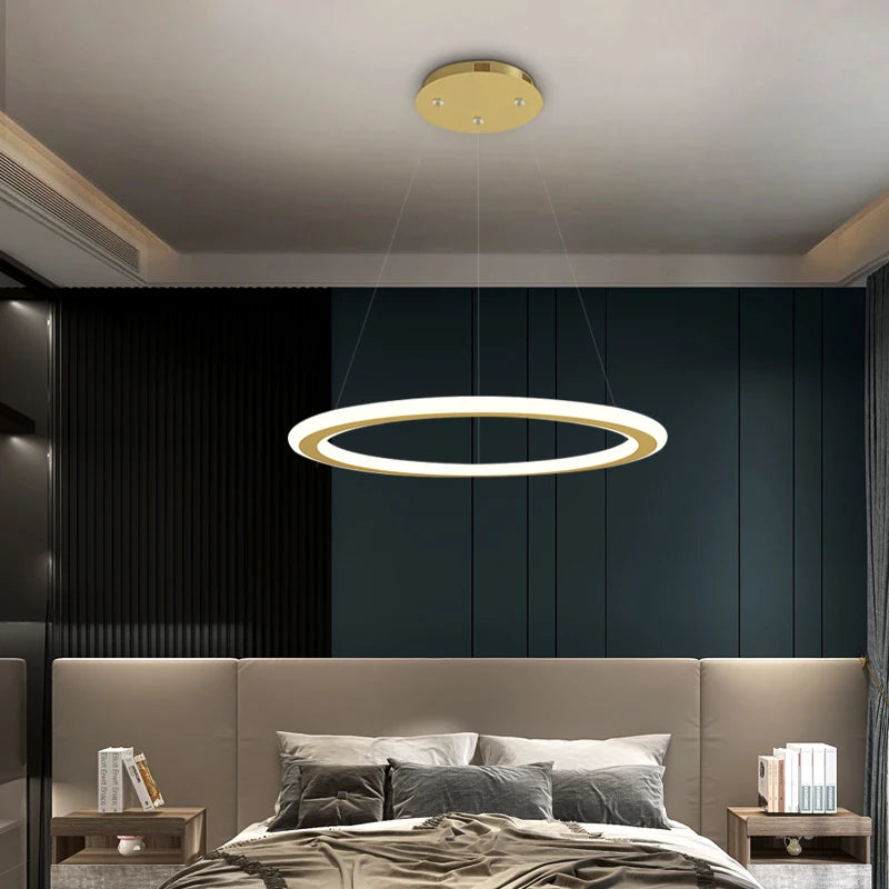 Minimalist circular LED chandelier illuminating a contemporary bedroom interior.
