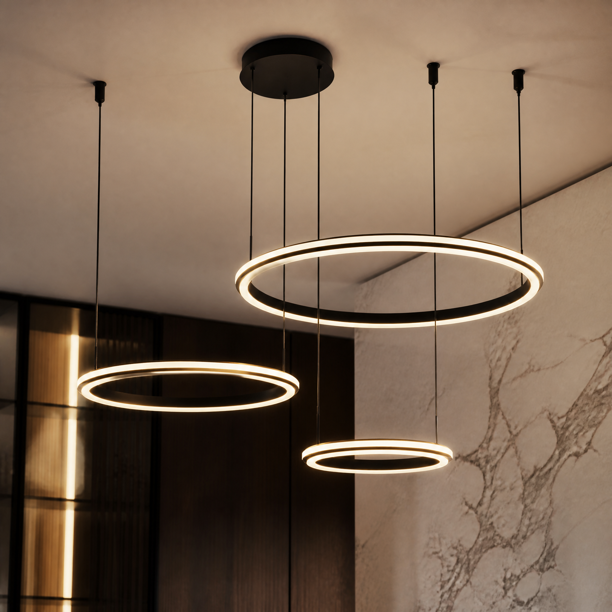 A detailed closeup shot of the VORELLI Bellezza Trio Chandelier showcasing the clean finishes of the three energy-efficient LED circular tiers.