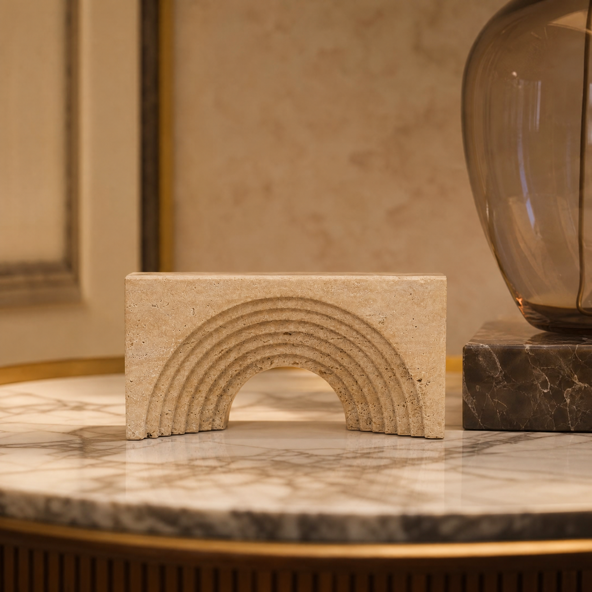 Macro closeup of the VORELLI Belvista decor, highlighting the meticulously etched concentric arches and rustic finish on the carved natural stone.