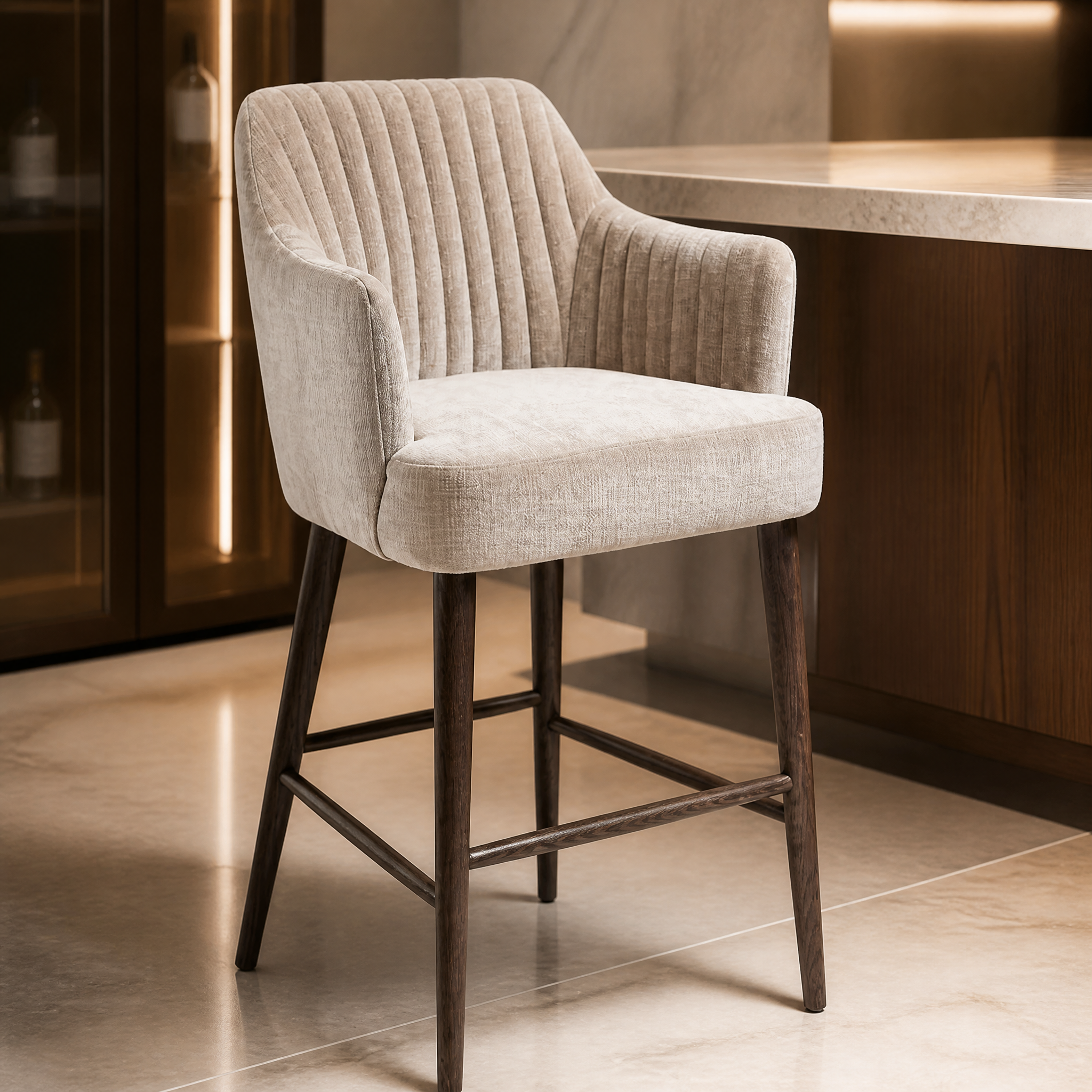 Close-up detail of the VORELLI Blevano bar stool showcasing the refined texture of the warm latte fabric upholstery and the rich dark brown frame.