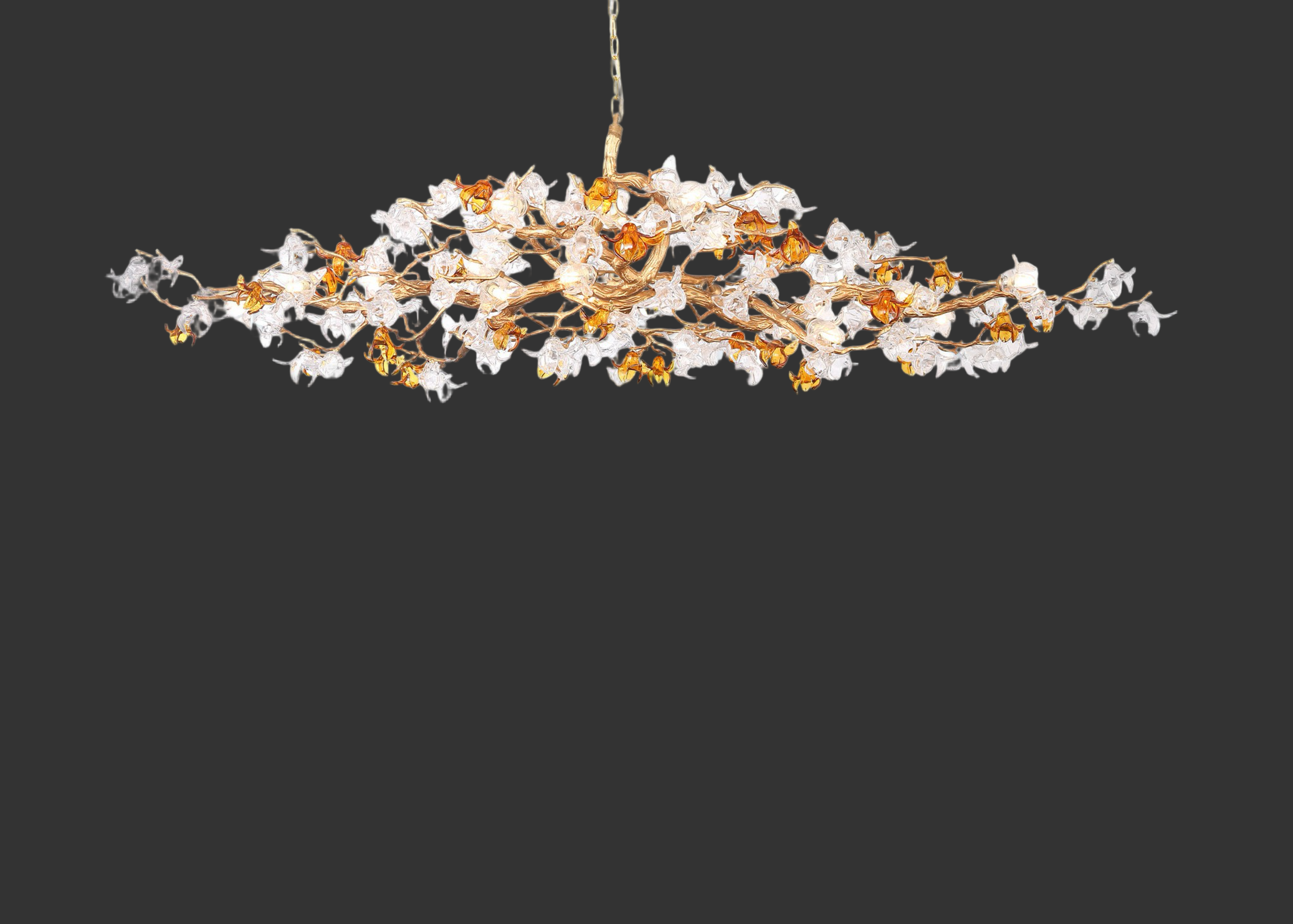 Bloom rectangular chandelier with sculptural branching frame and amber and clear glass flowers.