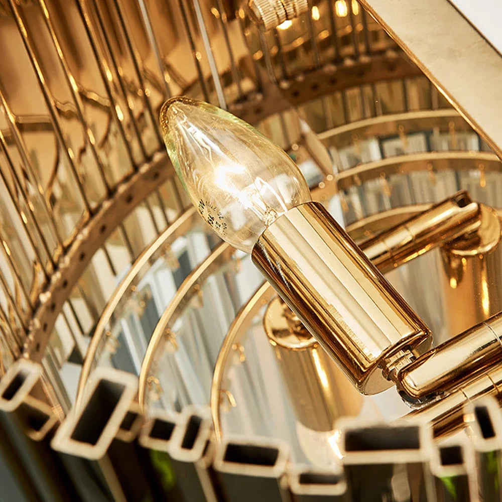 Close-up of the Boeotia Wall Light II highlighting polished gold tubing and faceted crystal bars.