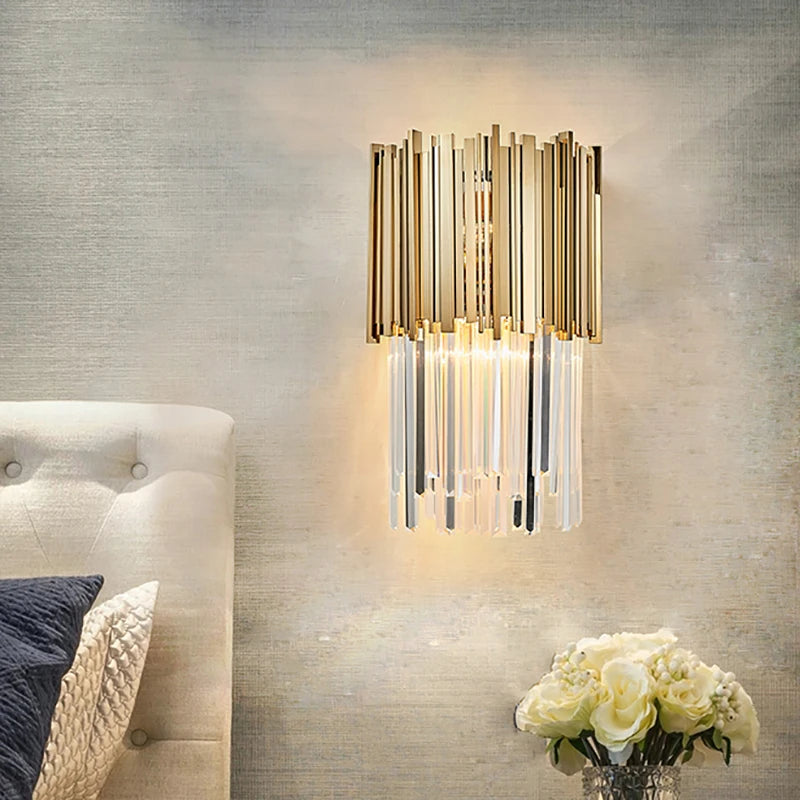 Boeotia Wall Light II mounted in a luxury living space, featuring gold cuboid tubing and shimmering crystal bars.