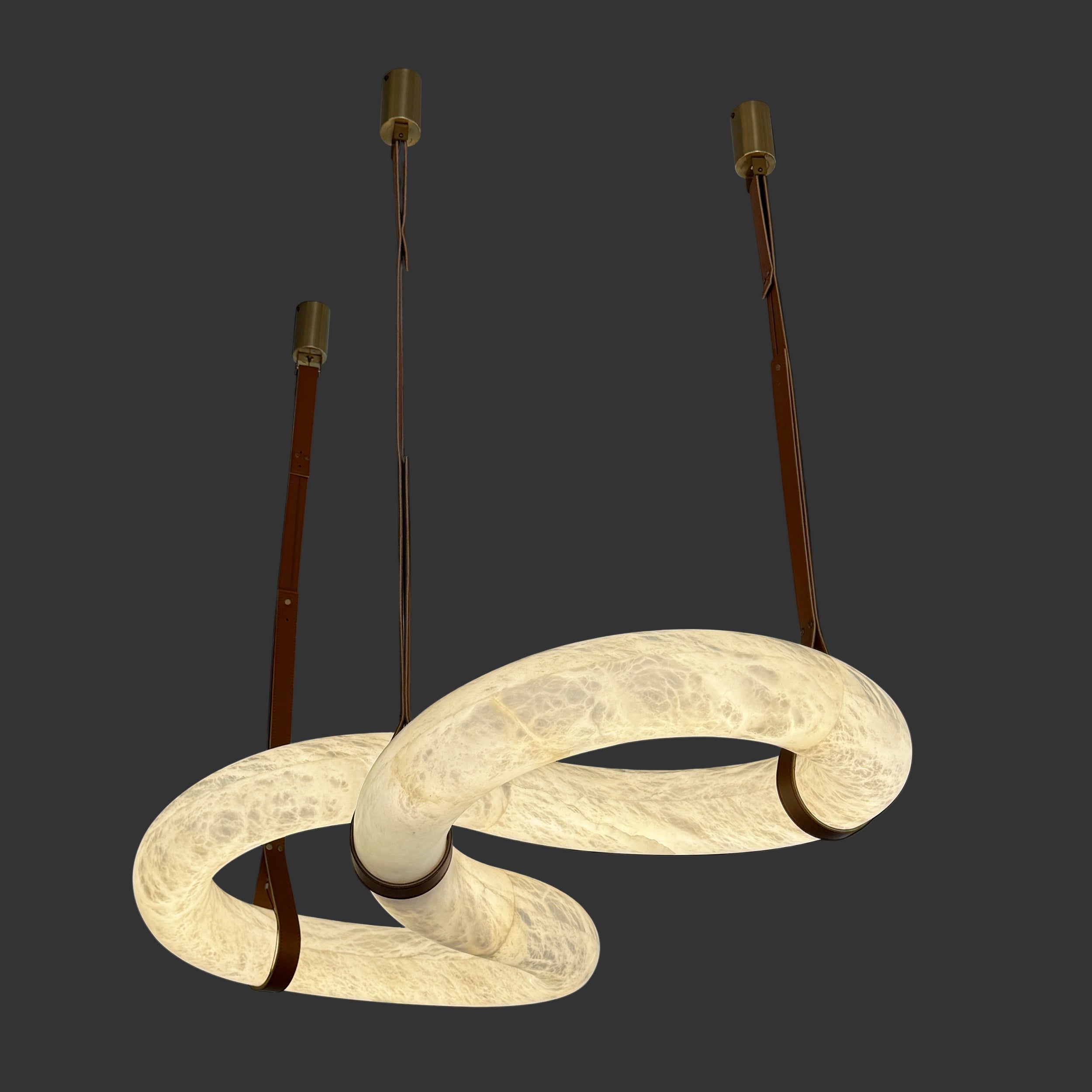 Botticino Loop Marble Rectangular Chandelier featuring illuminated sculptural marble loops suspended by minimalist gold supports.