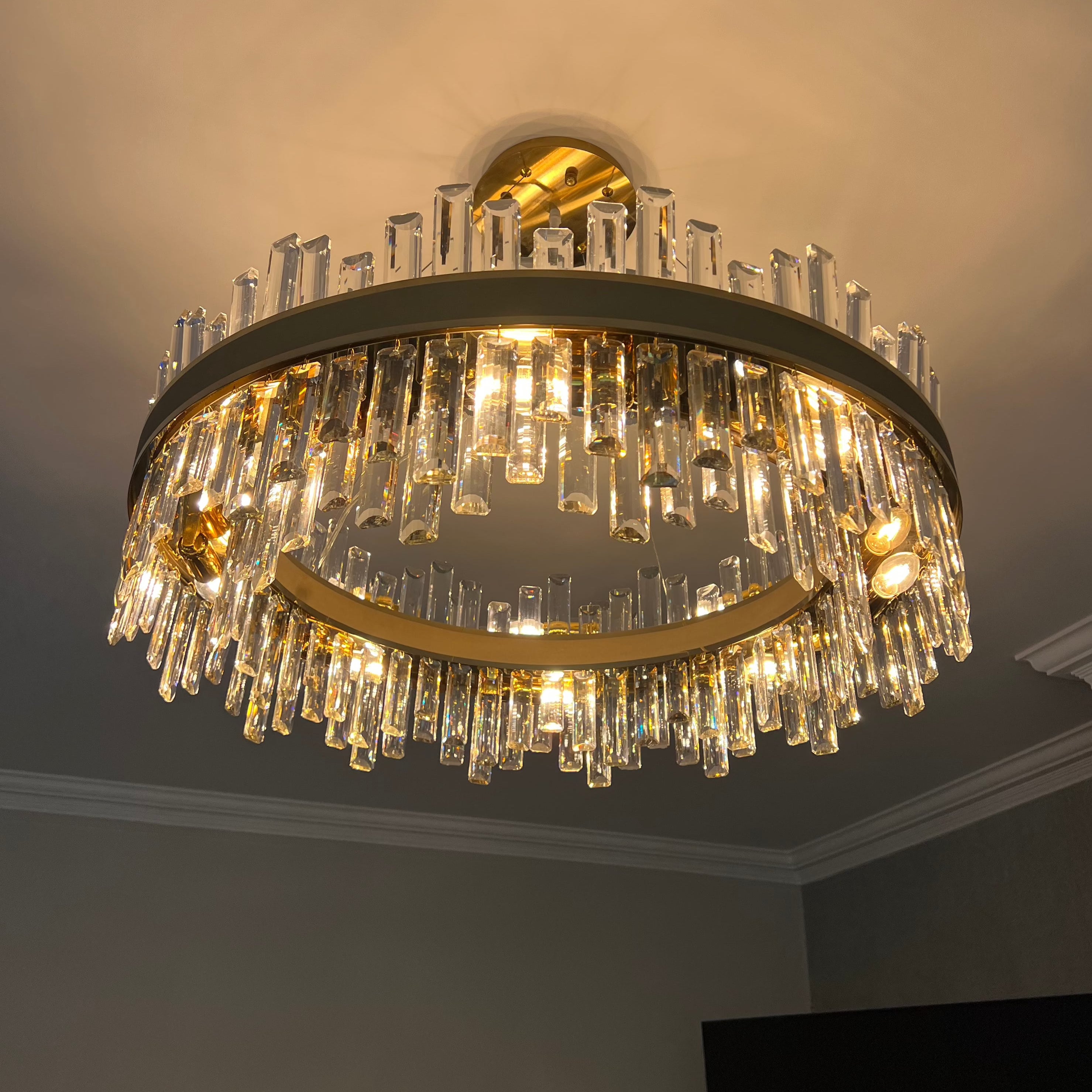 Brighouse Circular Chandelier displayed in a modern dining area with diamond-cut crystal prisms.