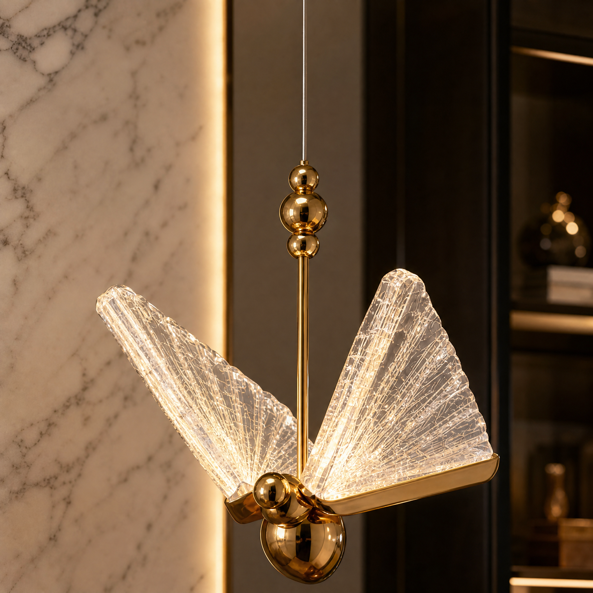 Detailed closeup of the VORELLI Butterfly pendant light highlighting the intricately sculpted crystal wings and refined artistic presence.