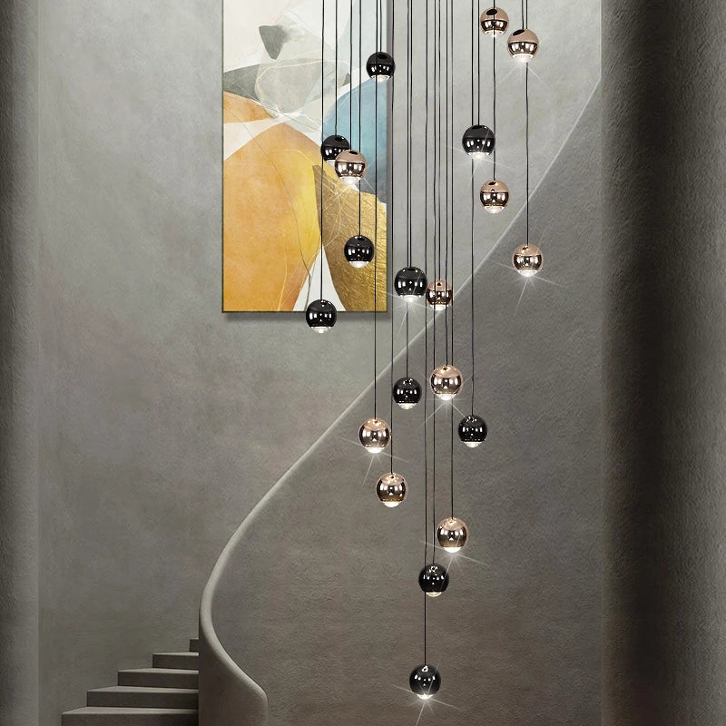 Carlito Pendant Staircase Chandelier with modern spheres cascading through a luxury staircase space.