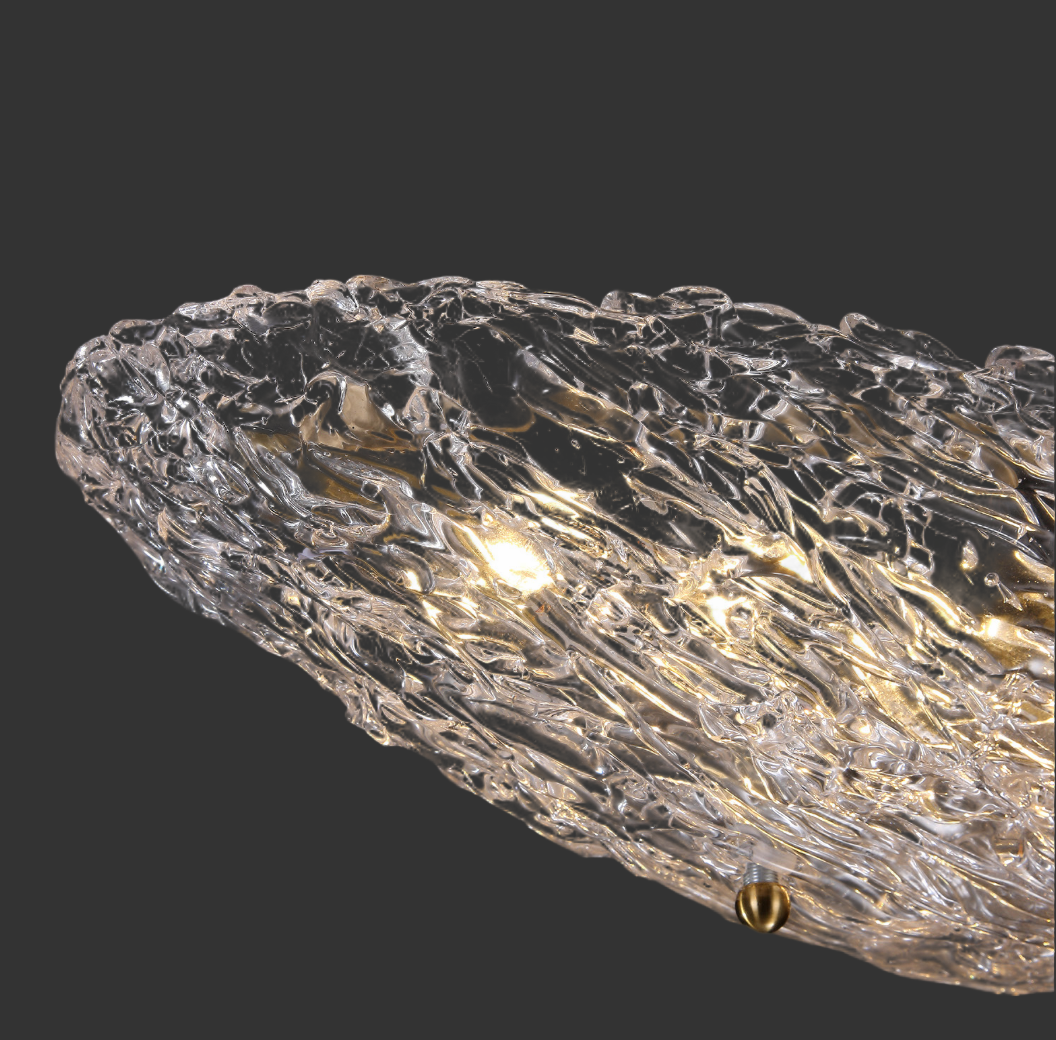 Close-up of Cascata pendant light showcasing textured sculpted glass and warm illumination