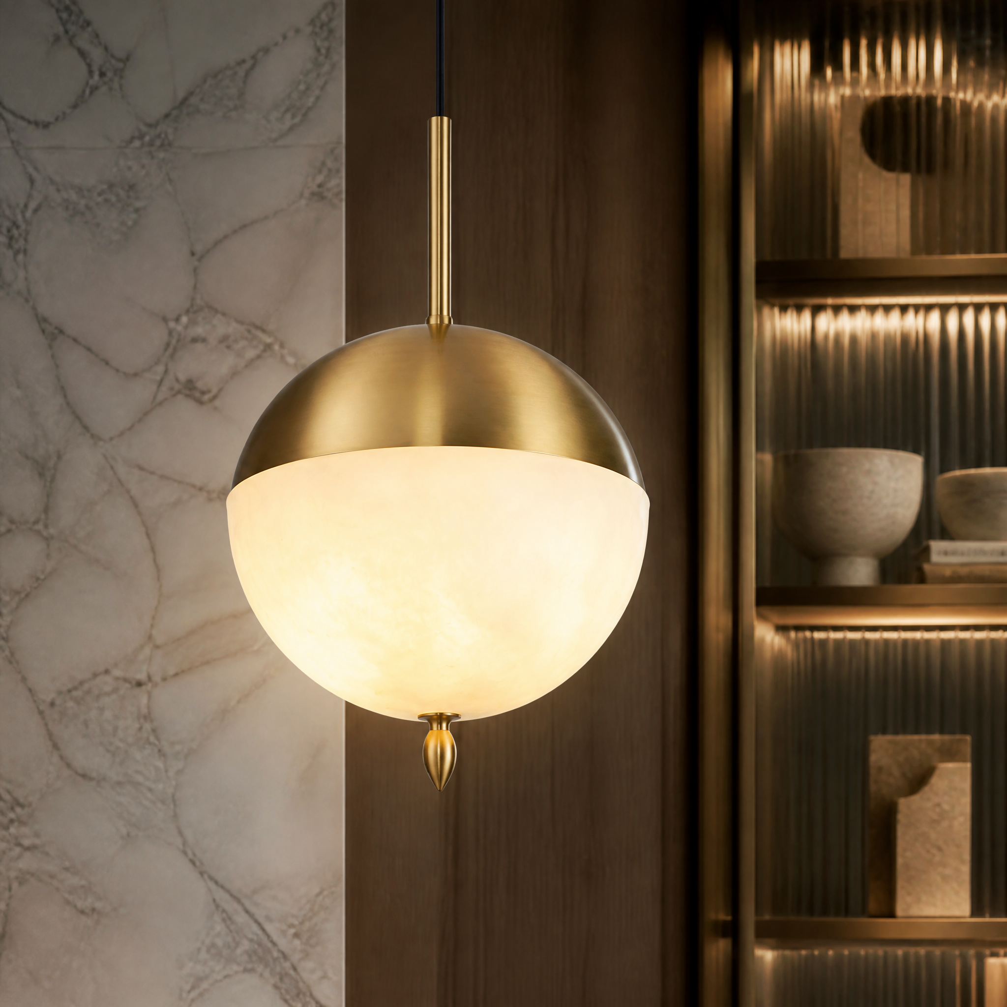 Macro shot of the polished brass finish and hand-carved marble details on the VORELLI Castano Pendant Light II.
