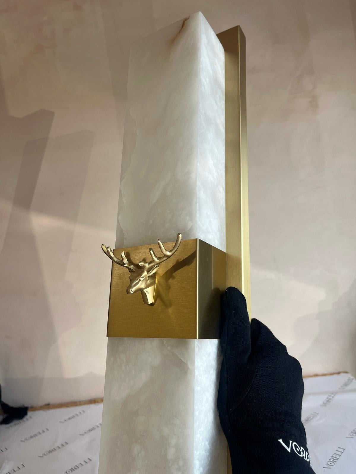 VORELLI Cervo marble wall light with sculpted white marble body and brushed brass deer motif detail