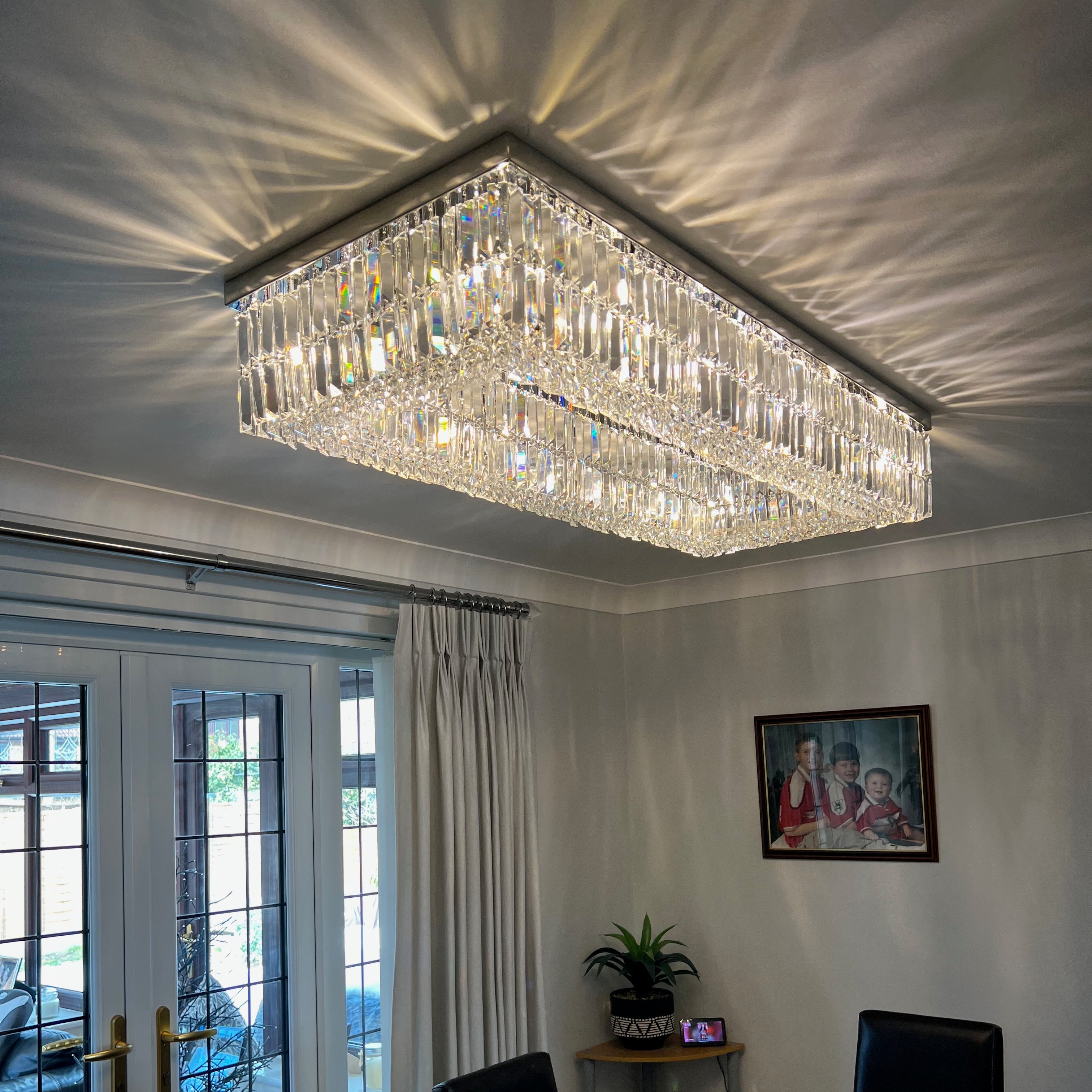 Rectangular crystal ceiling light shown at scale within a contemporary living space