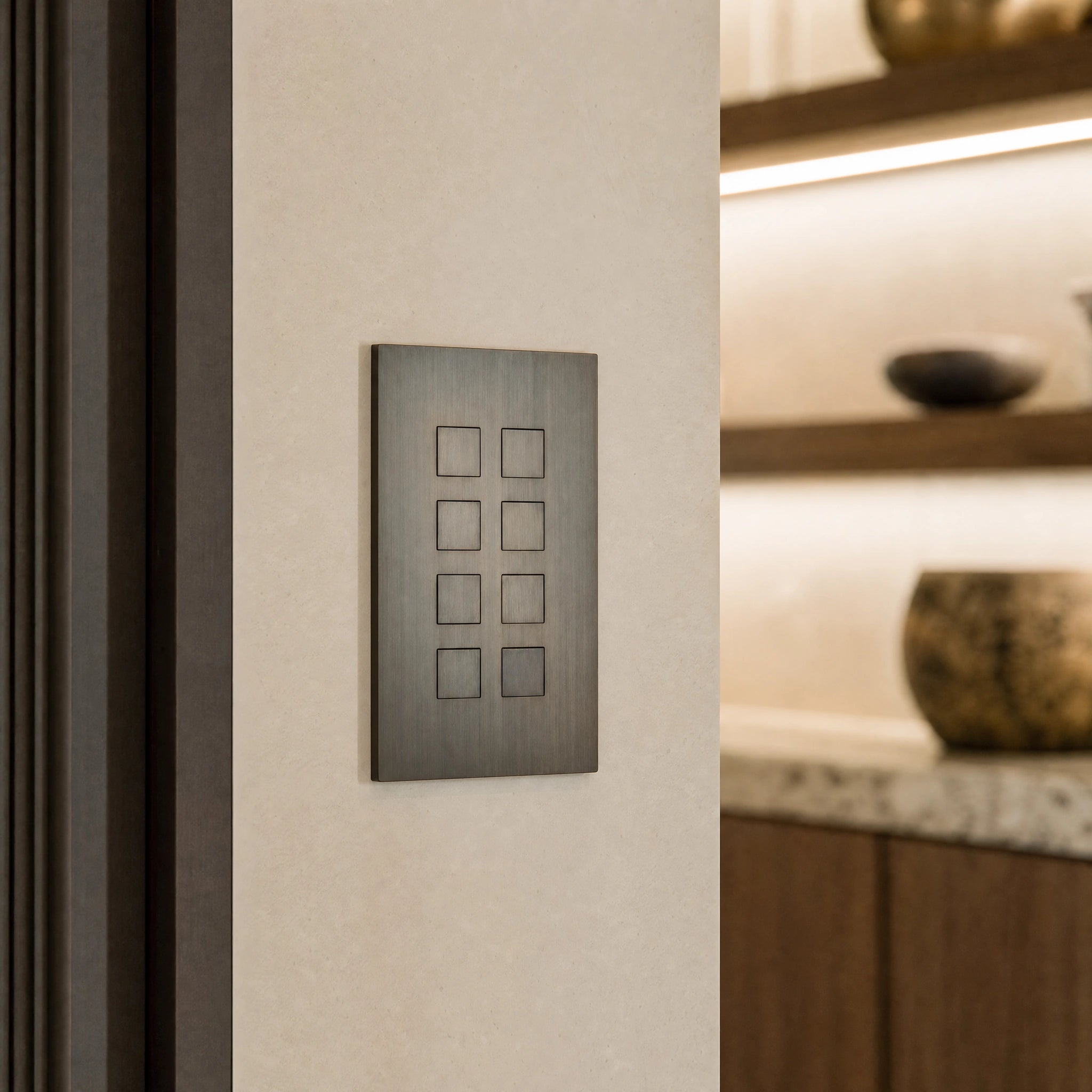 Close-up of a luxury umber control switch installed within architectural wall near layered lighting control in a private residence by VORELLI®.